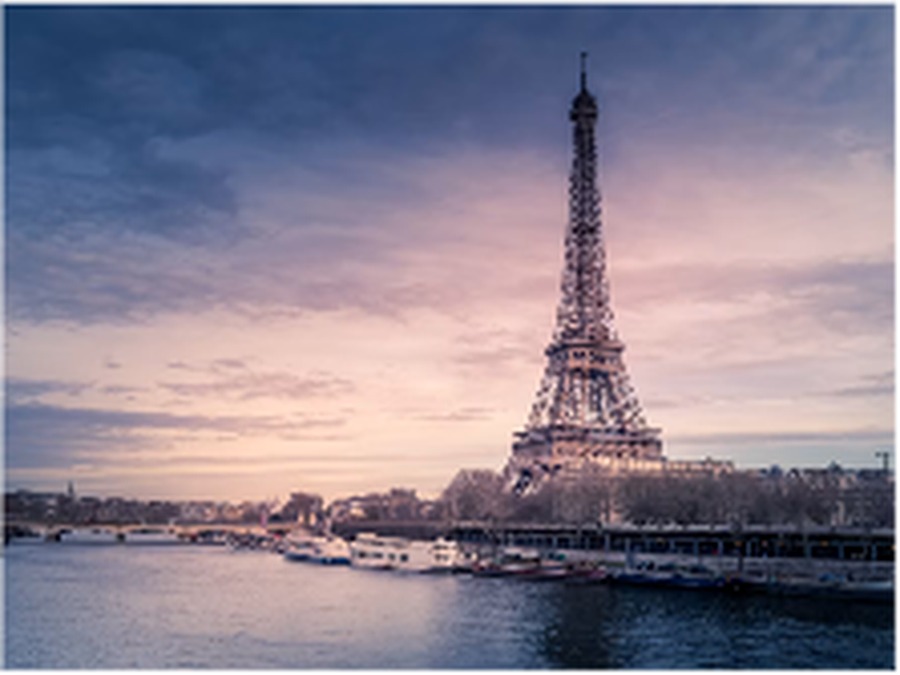 The Eiffel Tower above the Seine at dusk
