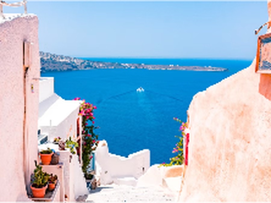 White houses above a deep blue bay on a Greek island